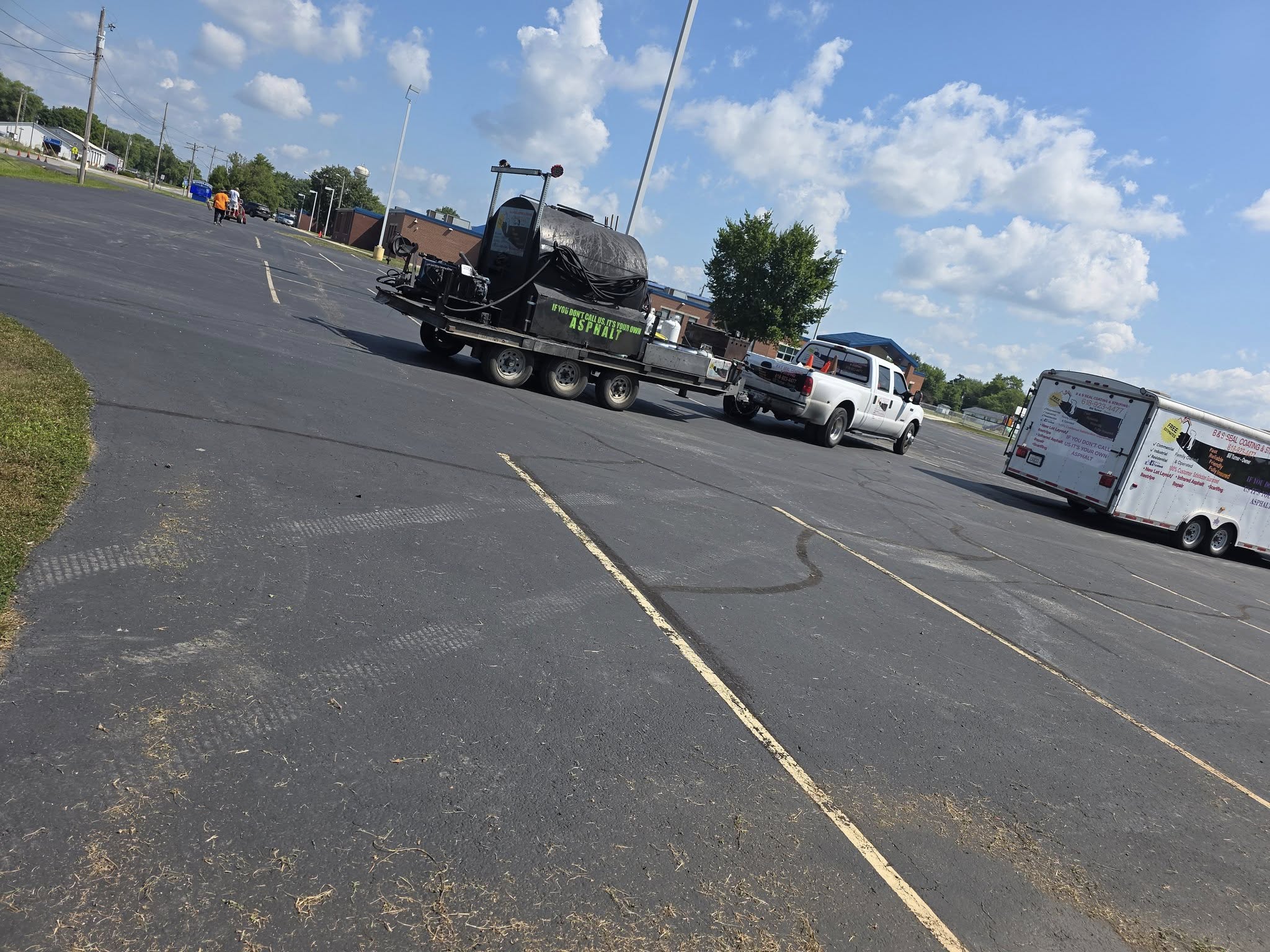 B&S Sealcoating professional equipment trailer and tank on site