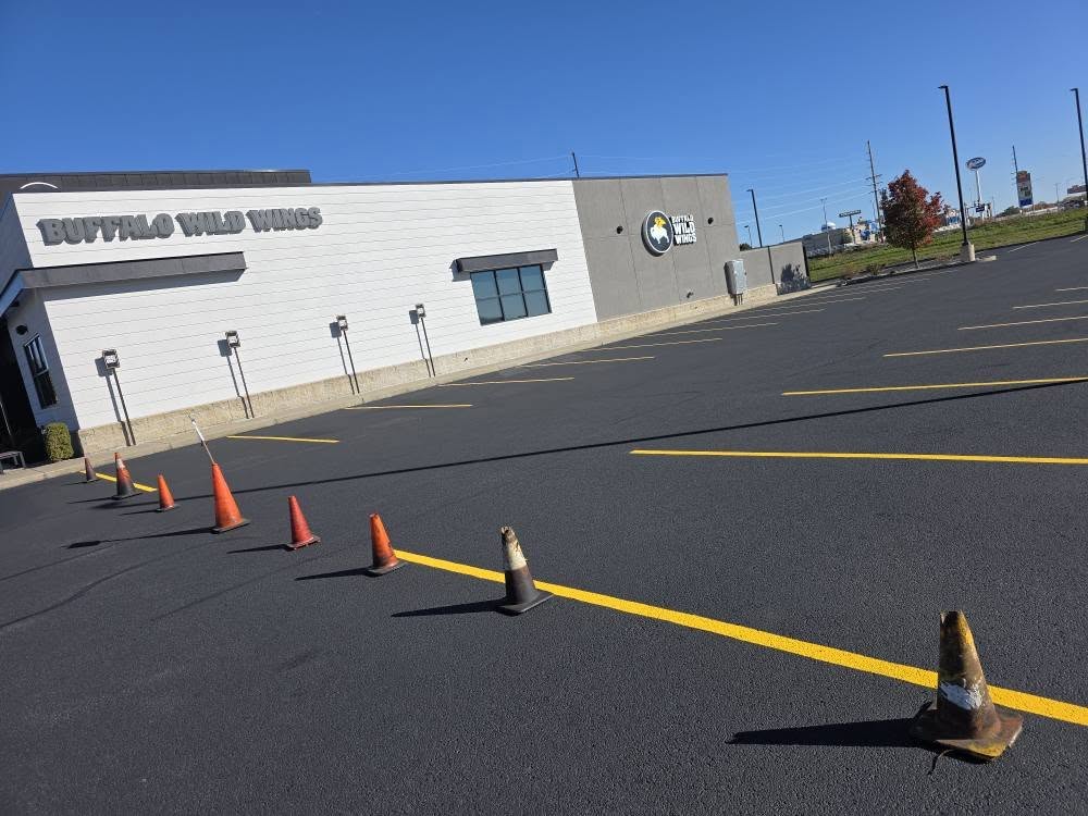 Freshly striped parking lot at Buffalo Wild Wings with cones for drying