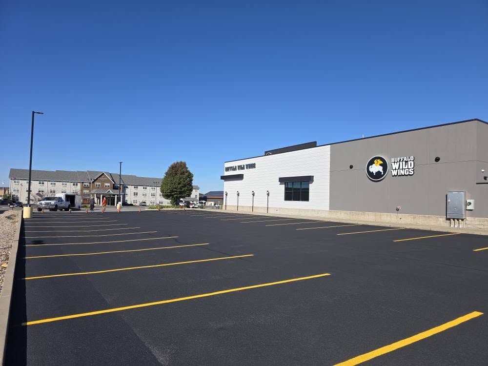 Extreme wide view of freshly completed parking lot for commercial client Buffalo Wild Wings