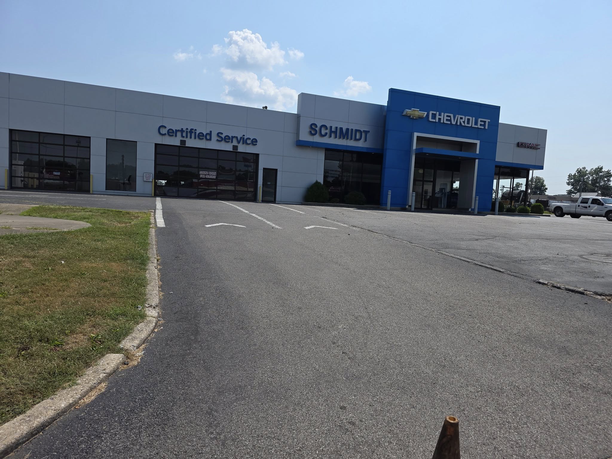 Asphalt driveway before sealcoating showing wear and fading